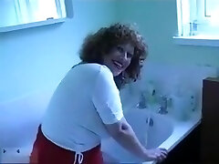 Mature woman with curly hair knows how to take a bath in a sexy way