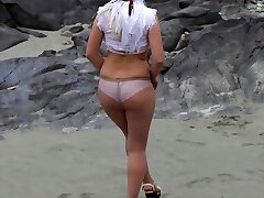 girlfriend in nylon pantyhose and stilettos posing by the river. a photo