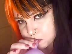 Punk girl blows up balloons