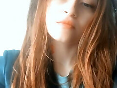 Redhead Chinese woman with tattoos blows smoke