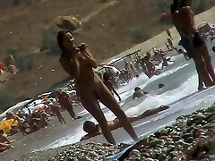 Voyeur flick of nude girls having fun on a naturist beach