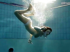 Brunette big tits nubile Andrea swimming in the pool