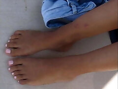 Young lady's footplay on the beach