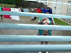 Naked in public. Neighbor saw pregnant neighbor in window who was drying clothes in yard without brassiere and panties. Nudist