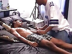 Slutty dude sucks cock while another drills his asshole hard in a steamy gay threesome