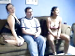 Geek Logan gets sucked and fucked by two horny girls on the sofa