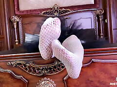 The Goddess in white fishnet tights foot teasing on the bed