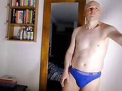 Man strips naked by mirror wanks his flaccid shaved cock till erect and shows his nude body and uncut cock