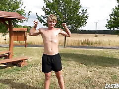 Cute teen blonde boy shows off his abs