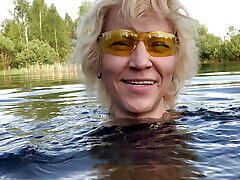 Transgirl Alexa Cosmic soaking and swimming in denim shorts and top and nude in the lake