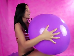 Adriana blow to pop a big purple balloon