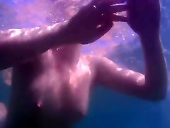 Teen Swimming Naked in the Sea Underwater