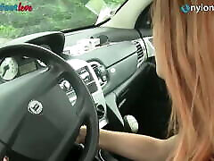 Redhead drives a car, shows hos msr in stockings